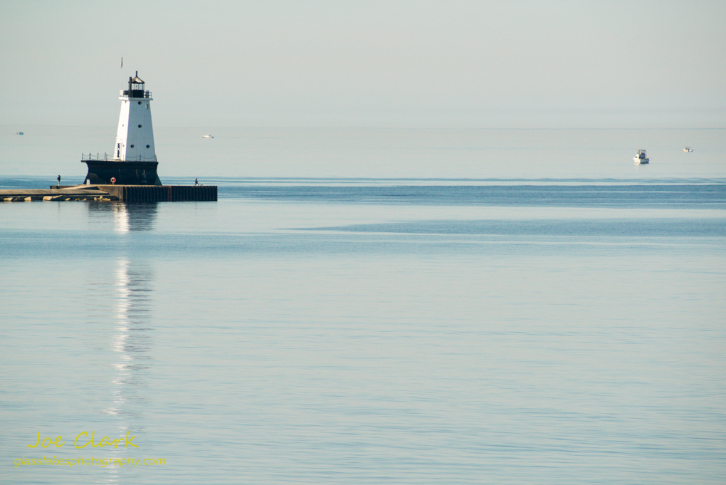 Fishing by the Ludington Lighthouse. By Joe Clark.